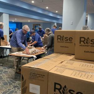 Employees packing up meals into boxes