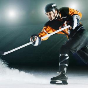 Hockey player hitting the puck