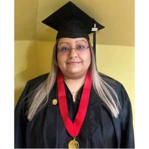 Elizabeth Arroyo Gomez stood smiling in a graduation cap and gown