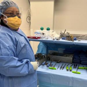 Elizabeth Arroyo Gomez stood next to a table of health care technology tools