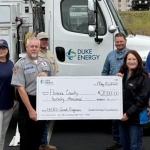 First responders holding check from Duke Energy
