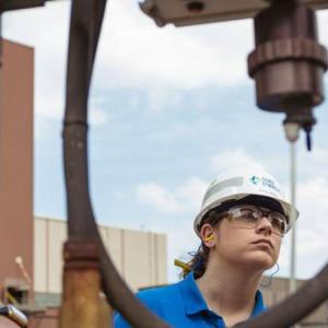 Emily Jones and two others inspecting equipment.