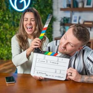 Emma Vaughn with a video clapper and a co-worker.