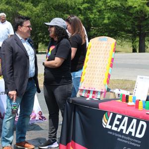 Two people stood talking at an event stand