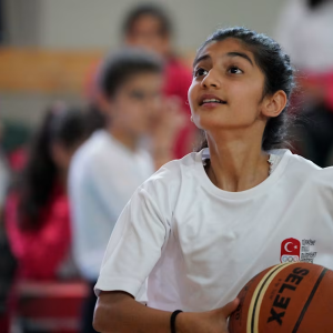 Student shooting basketball