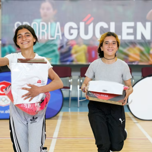2 students smiling with shoe boxes 