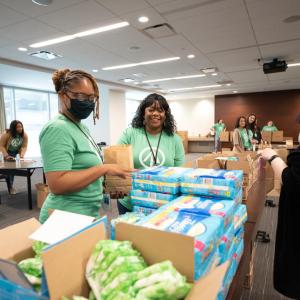 Women packaging menstrual health management supplies 