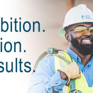 smiling duke worker with 'Ambition. Action. Results'