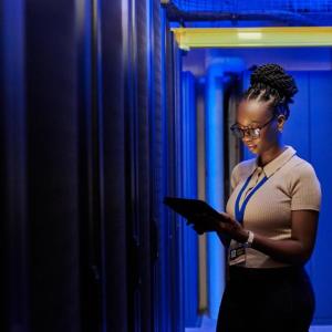 Young woman with glasses looking at a clipboard