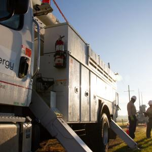 Entergy employees standing with truck
