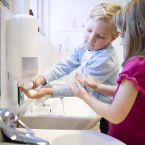 Children washing their hands.