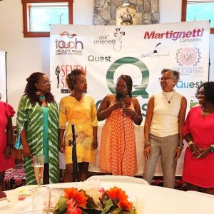 Panelists in a row at the front of the room.