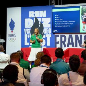 Two people talking on stage in front of an audience 