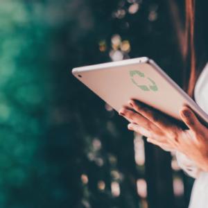 Person standing, looking at tablet