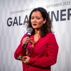 Person holding an award and giving a speech at the Global Cyber Conference 