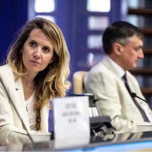 Two people seated next to one another at FAO-CEMA Signing Ceremony
