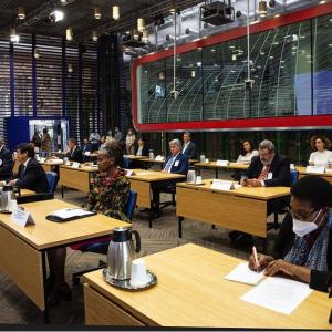 Several people seated at desks during FAO-CEMA Signing Ceremony