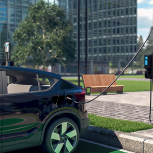 a vehicle plugged in to a charging station, buildings in the background