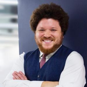 Person with arms crossed smiling