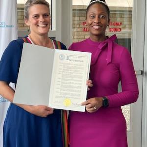 Dutchess County Mental Health Commissioner Jean-Marie Niehbur (left) presents a proclamation on half of County Executive Sue Serino’s office to KeyBank’s Senior Area Retail Leader Irenee Provenzano.