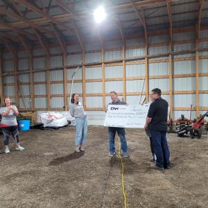 Two people holding a large cheque 