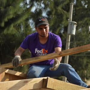 FedEx volunteer lifting building materials