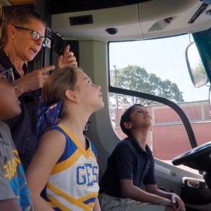 4 people sitting in the front seats of a van