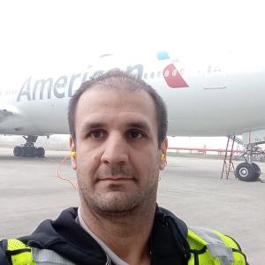 A person taking a selfie in front of an aeroplane