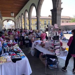 A long covered walkway with craft vendors.