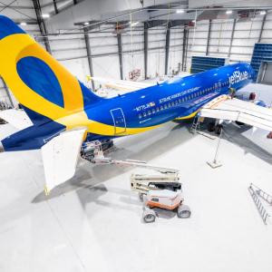 Blue and yellow airplane in hangar
