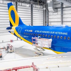 Blue and yellow airplane in hangar