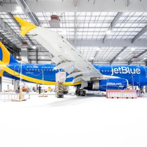 Blue and yellow airplane in hangar