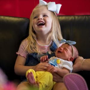 Child holding a baby