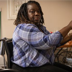 Photo of Melanie shown seated in a wheelchair.