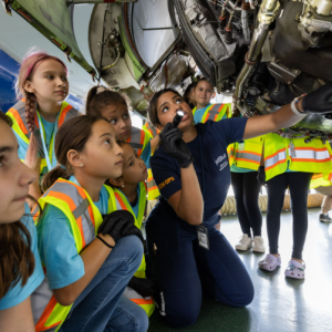 girls looking at an airplane