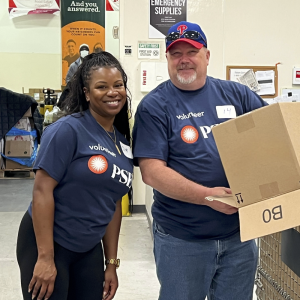 Two volunteers smiling