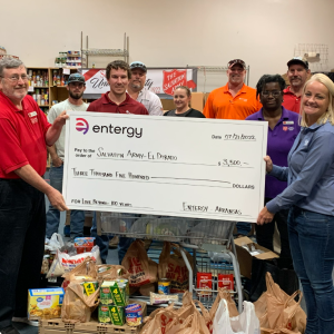 people holding up oversized check from Entergy