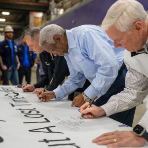 Fort Smith Police Chief Danny Baker, Fort Smith Mayor George McGill and Congressman Steve Womack sign a banner celebrating Trane Fort Smith achieving 5,000,000 hours without a lost time injury