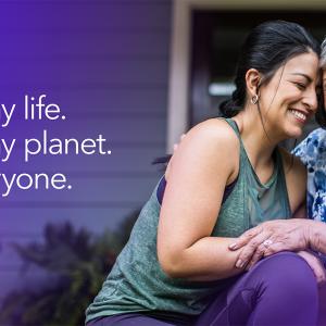 2024 Impact Report Cover Page, showing two people laughing and embracing on the doorstep of a home