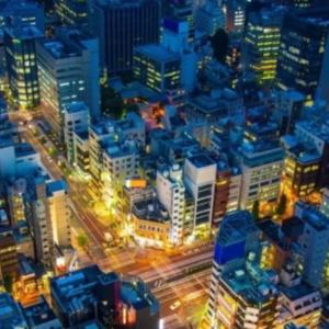 a nighttime city scape, long time-elapsed cars on brightly lit streets