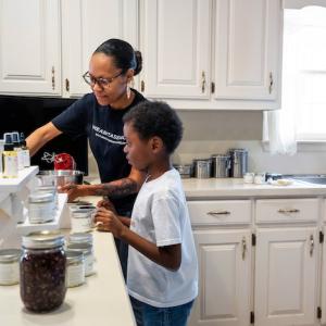 Jennifer Woodruff, Naturally Made with Love; Mom and her son packing a box.