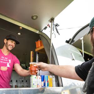 ET Rivera, Tres Leches Café; serving a customer at his cafe.