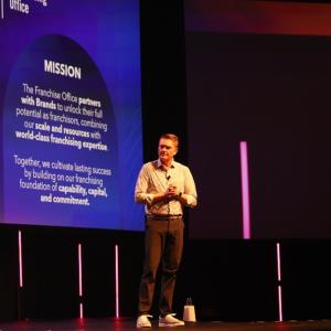 Presenter on stage at GFC