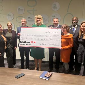 The Girl Scouts of Western Washington accepting a grant check for $150,000 from KeyBank