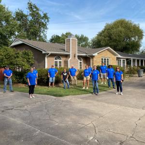 GP team posing in front of house