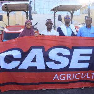 Gaalooge Team Members holding a banner that reads, "CASE IH"