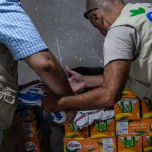 Two Action Against Hunger workers unloading boxes