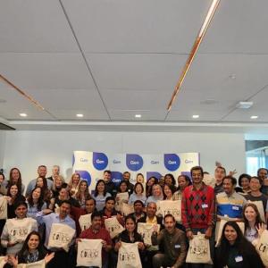 A large group of people holding bags with "Courage" on them.