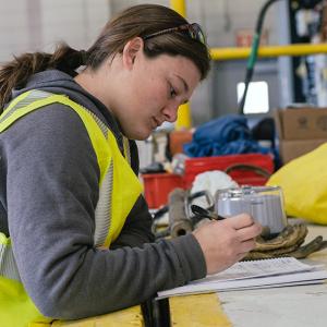 Georgia Hummel looking at paperwork on a work table.