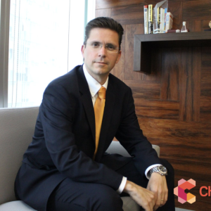 Gerardo Familiar seated in a casual setting, a wood bookcase behind him. Chemours logo in the right corner.